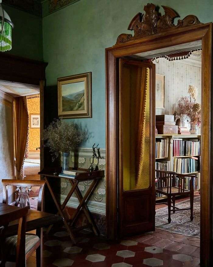 Vintage bold and beautiful interiors with wooden furniture, intricate decor, and warm cozy lighting in a classic home setting