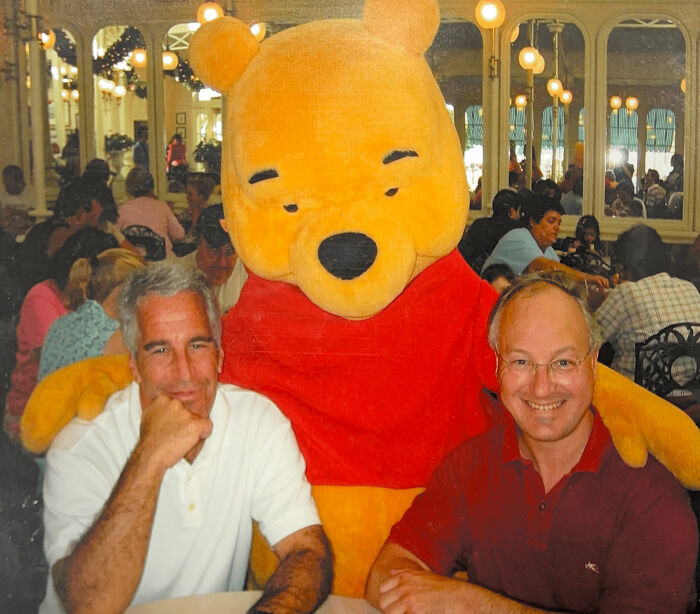 Two men sitting with a large Winnie the Pooh mascot, unrelated to new Epstein emails about horrifying plants he grew. Two men sitting with a large Winnie the Pooh mascot, unrelated to new Epstein emails about horrifying plants he grew.