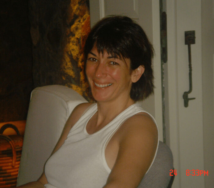 Woman smiling indoors on a white chair, related to former inmate revealing foul details about Ghislaine Maxwell in prison. Woman smiling indoors on a white chair, related to former inmate revealing foul details about Ghislaine Maxwell in prison.