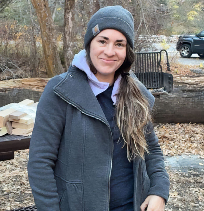 Woman outdoors in a gray jacket and beanie, symbolizing four missing kids returned to dad after foreign orphanage abduction.
