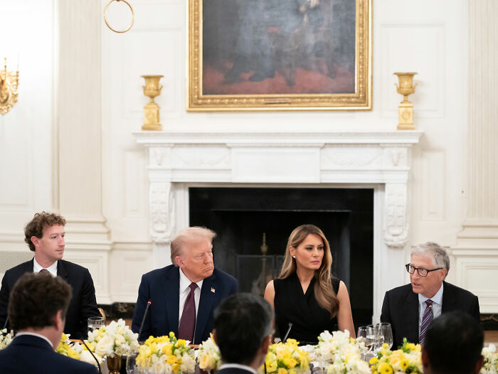 Bill Gates in a formal meeting, seated beside notable figures, discussing Epstein files amid recent ex-wife accusations.