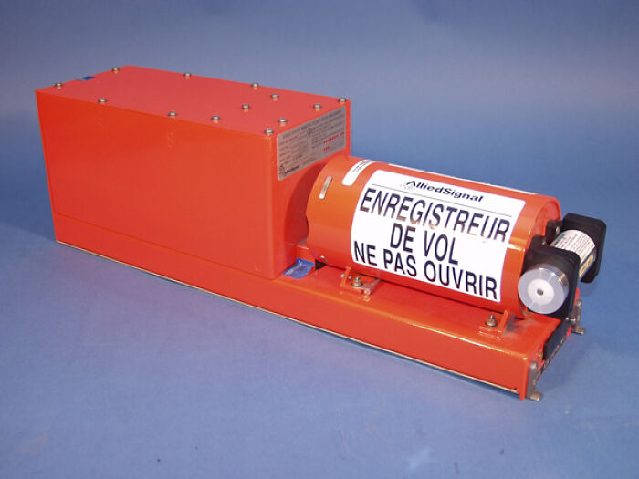Orange flight recorder device with a label in French against a blue background, related to today I learned facts.