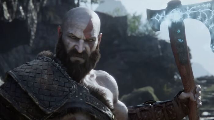 Kratos from God of War holding an enchanted axe in a rugged outdoor setting, related to God of War TV series.