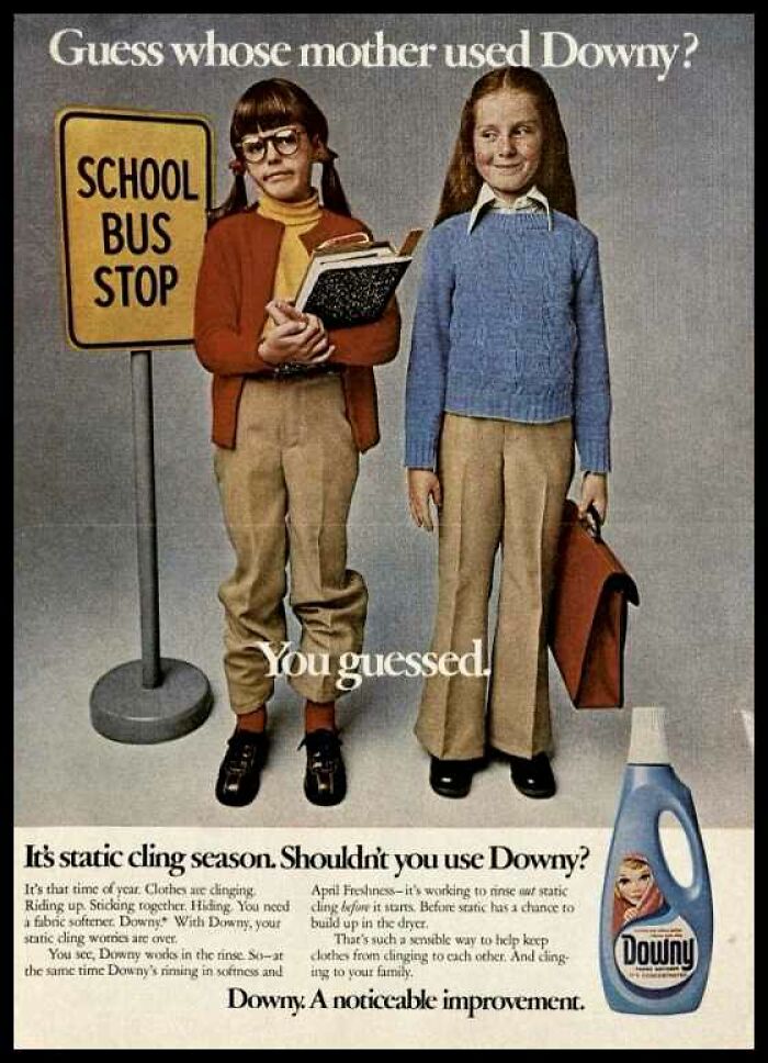 Two girls standing at a vintage school bus stop in a 1970s American ad for Downy fabric softener and static cling.