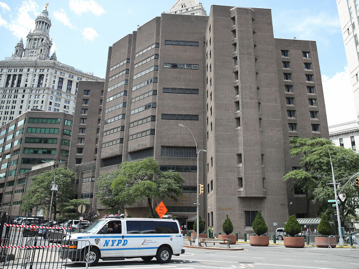 NYPD van outside a large building related to Jeffrey Epstein post mortem investigation in an urban setting. NYPD van outside a large building related to Jeffrey Epstein post mortem investigation in an urban setting.
