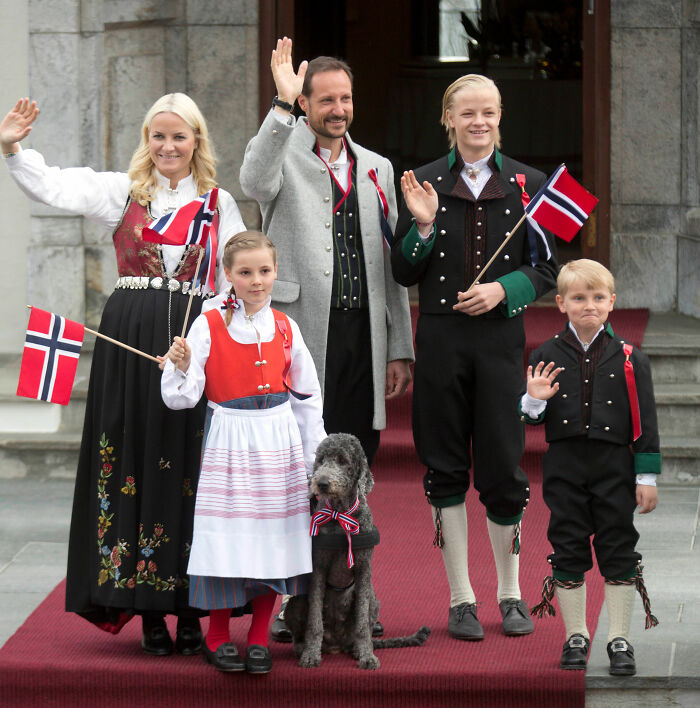 Norway's Crown Princess family waving, with son in traditional attire, linked to court incident over videos as proof of crimes.