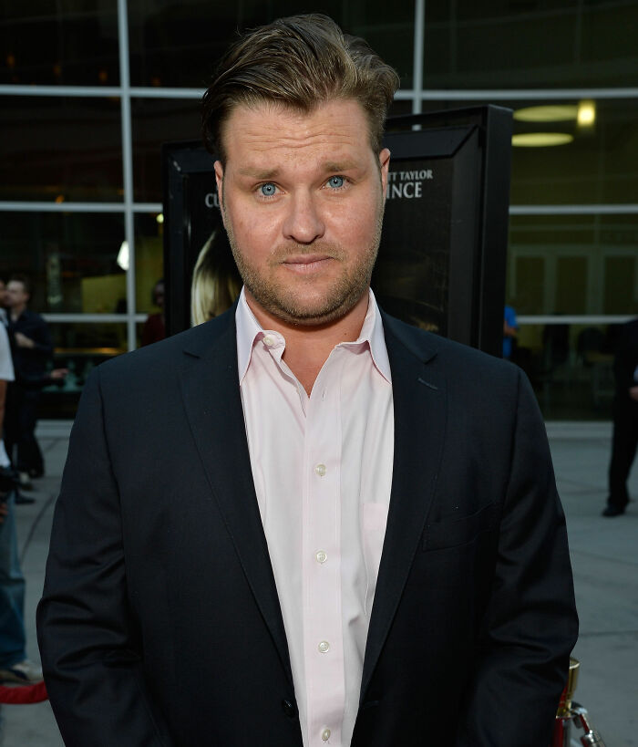 Actor Zachery Ty Bryan from Home Improvement attending an event, wearing a dark blazer and white shirt.