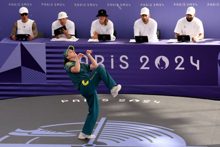 Australian athlete in Olympic sport performing under judges at Paris 2024, showcasing Olympic sports intensity and focus.