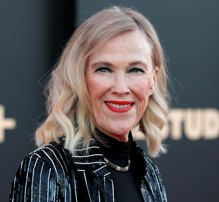 Smiling woman with blonde hair wearing a black sequin jacket, representing colon cancer breakthrough awareness event.