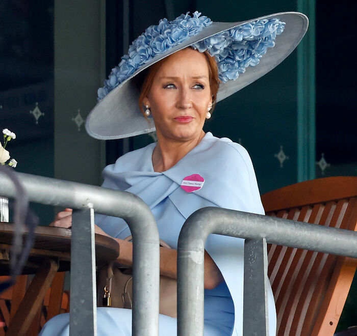 Woman wearing a large blue hat and dress, representing JK Rowling amid Harry Potter fans furious over Epstein documentary.