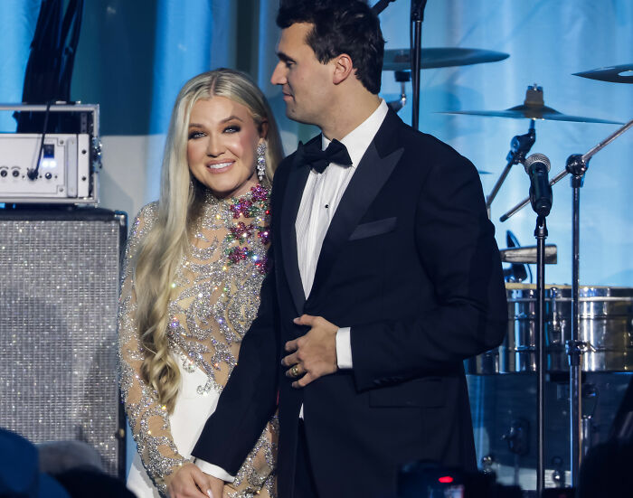 Erika Kirk and husband Charlie dressed formally at an event, amid backlash and TSUPA response to office changes.