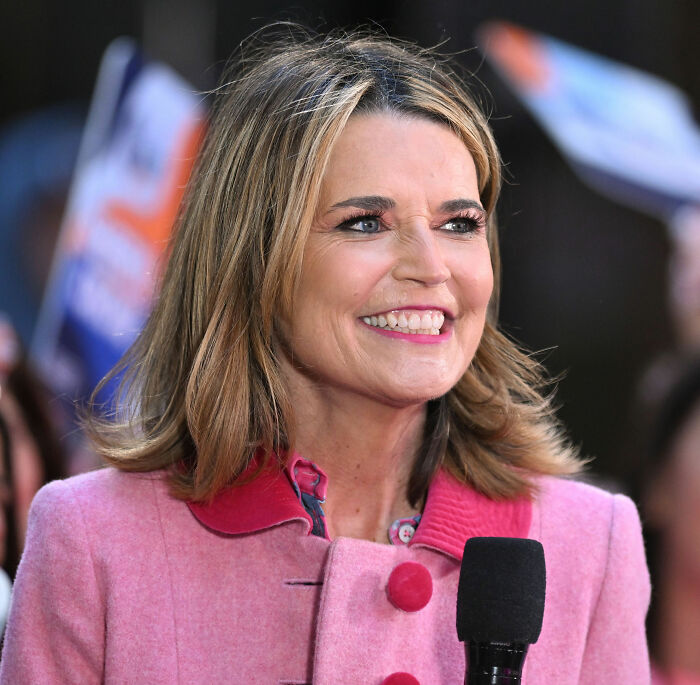 Savannah Guthrie smiling during an outdoor interview amid growing police theories about her mom’s Arizona disappearance.