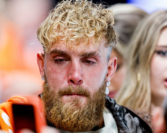 Bearded man with curly blonde hair looking serious, unrelated to Olympian Jutta Leerdam exposing underwear during ice event.