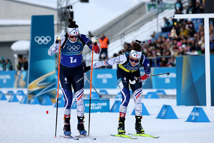 Two athletes competing in an Olympic winter sport race, showcasing the intensity of Olympic sports competition.