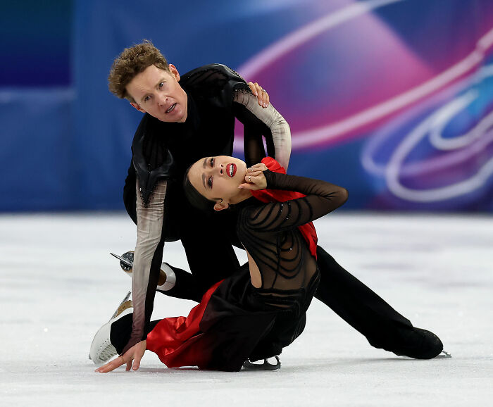 Male and female figure skaters performing a dramatic routine on ice representing US figure skating after cheating scandal.