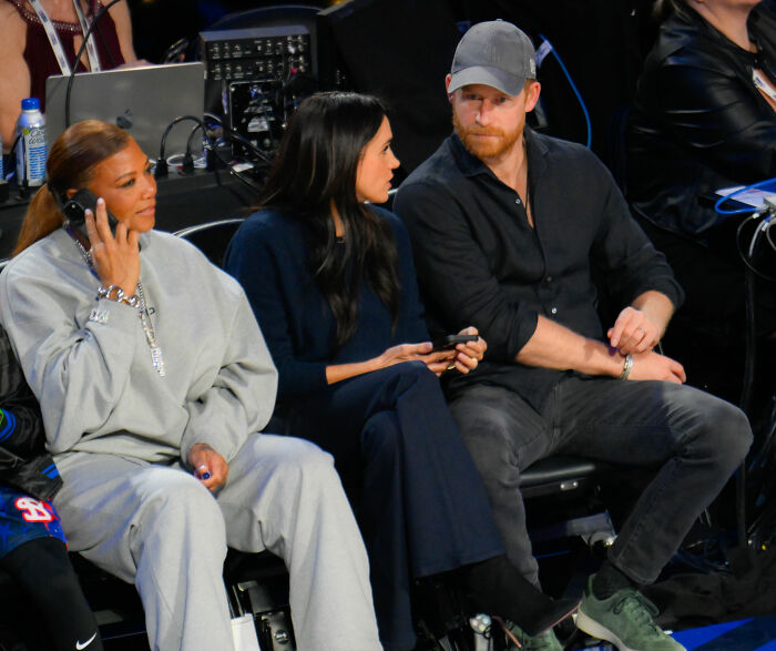 Prince Harry and Meghan Markle seated courtside at NBA All-Star Game displaying engaged body language. Prince Harry and Meghan Markle seated courtside at NBA All-Star Game displaying engaged body language.