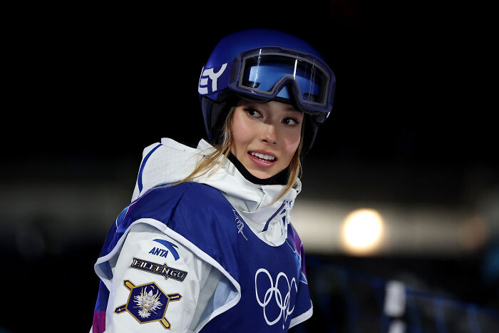 Athlete Eileen Gu in ski helmet and gear, captured during Olympic event amid JD Vance’s comment backlash.