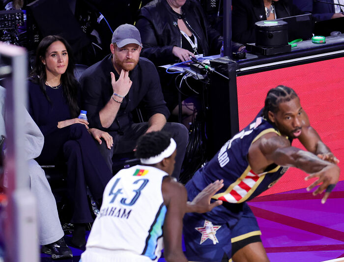 Prince Harry and Meghan Markle seated courtside at NBA All-Star Game, Prince Harry's body language drawing attention. Prince Harry and Meghan Markle seated courtside at NBA All-Star Game, Prince Harry's body language drawing attention.