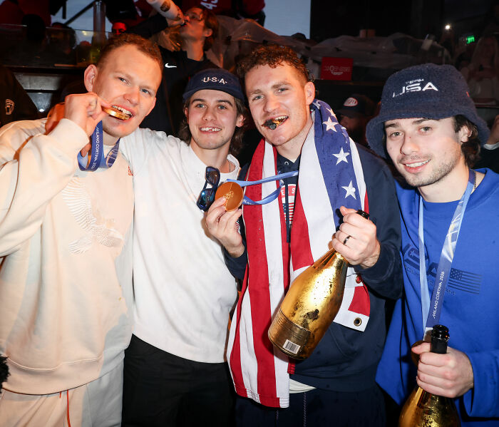 Team USA men's hockey players celebrating with medals and champagne, sparking controversy after White House visit. Team USA men's hockey players celebrating with medals and champagne, sparking controversy after White House visit.
