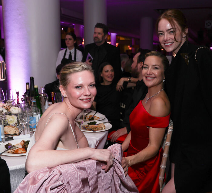 Kirsten Dunst smiling with guests at the 2026 BAFTA afterparty amid a notable fashion emergency and blunder.