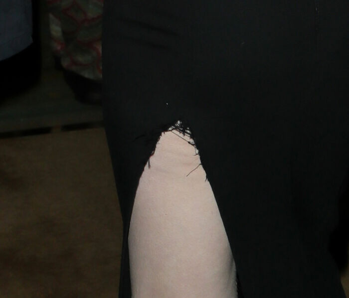 Close-up of a black dress with a torn slit, highlighting a fashion emergency at the 2026 BAFTA's afterparty.