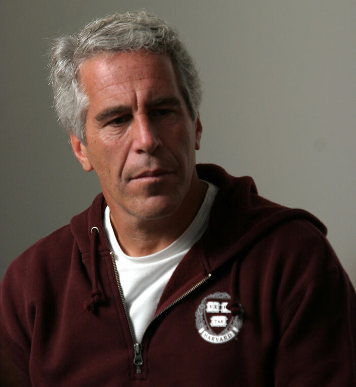 Man in casual attire with gray hair, looking down thoughtfully in a neutral setting relating to Jeffrey Epstein post mortem claims. Man in casual attire with gray hair, looking down thoughtfully in a neutral setting relating to Jeffrey Epstein post mortem claims.