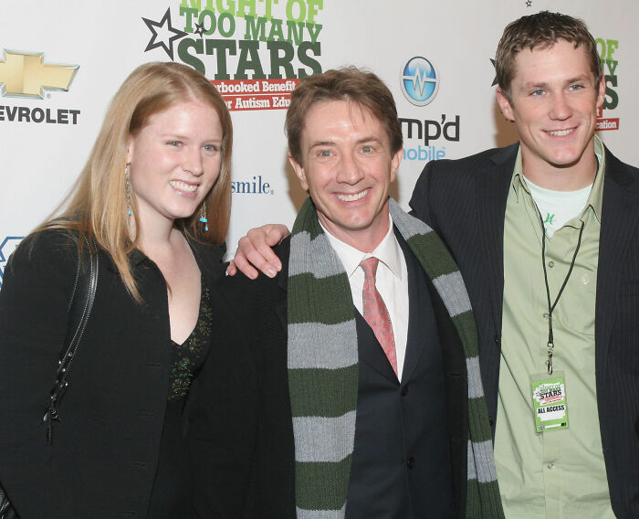 Martin Short smiling with two young adults at a charity event, related to harrowing 911 audio and tragic loss.