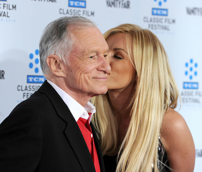 Hugh Hefner with his widow sharing a close moment at a public event, related to Playboy founder claims.