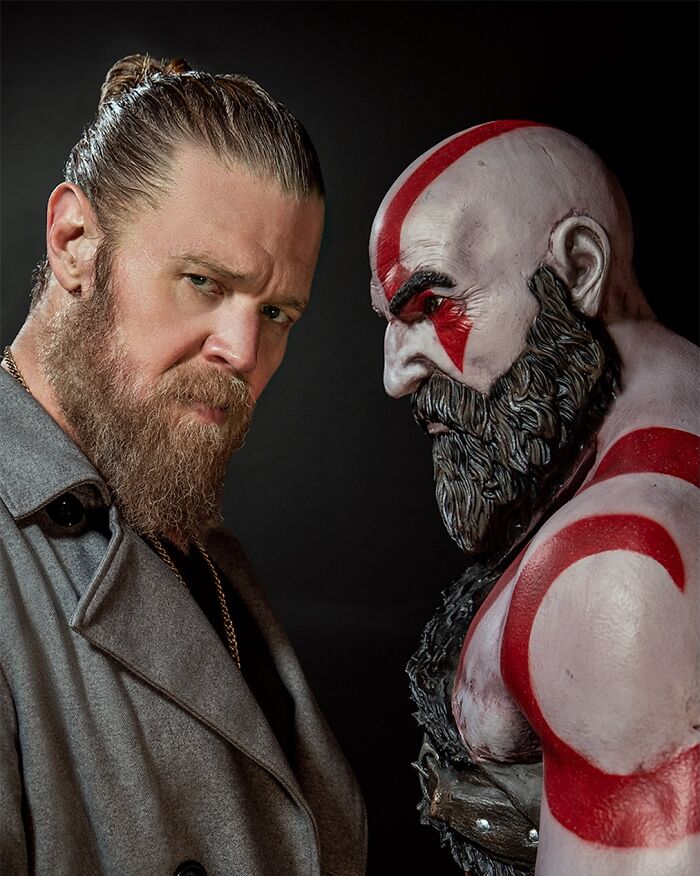 Actor posing next to Kratos figure for God of War TV series cast and release date update.