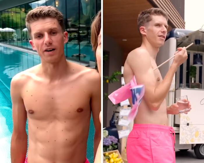 Shirtless Winter Olympics athlete wearing pink shorts near pool and holding flag, showcasing sporty summer vibe.
