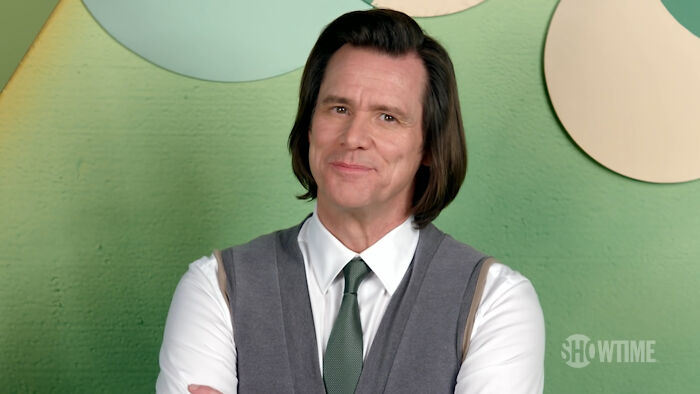 Jim Carrey smiling in a vest and tie, representing iconic actors who dominated Hollywood but then vanished without explanation.