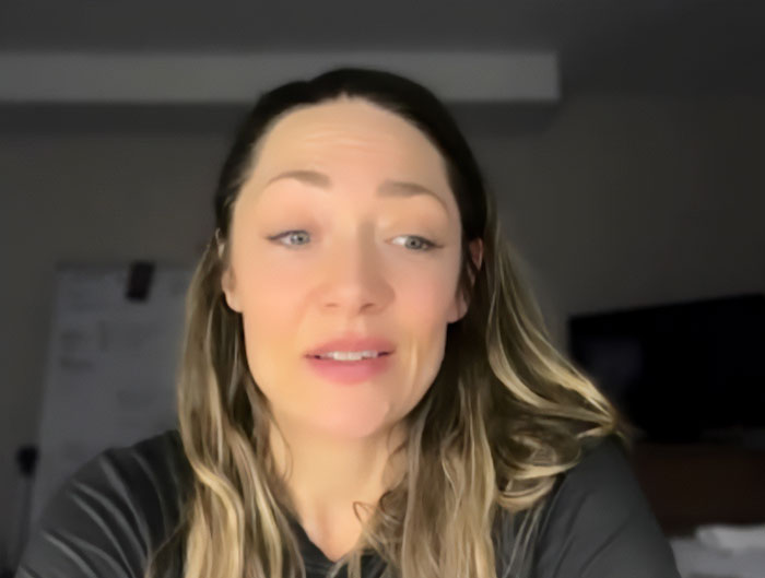 Woman with long hair in a dark shirt speaking about Olympics and major change after Canada cheating accusations.