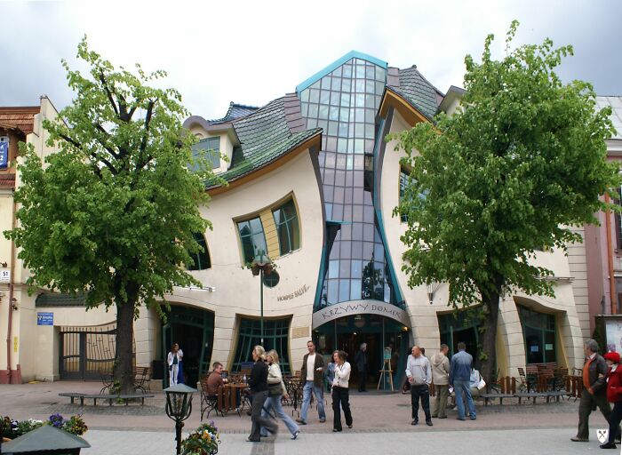 Unique and unusual places worldwide featuring the famous Crooked House building with distorted architecture and visitors.