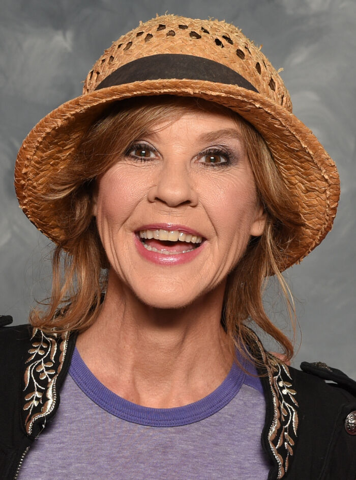 Smiling iconic actress wearing a straw hat and purple shirt, representing Hollywood actors who vanished without explanation.