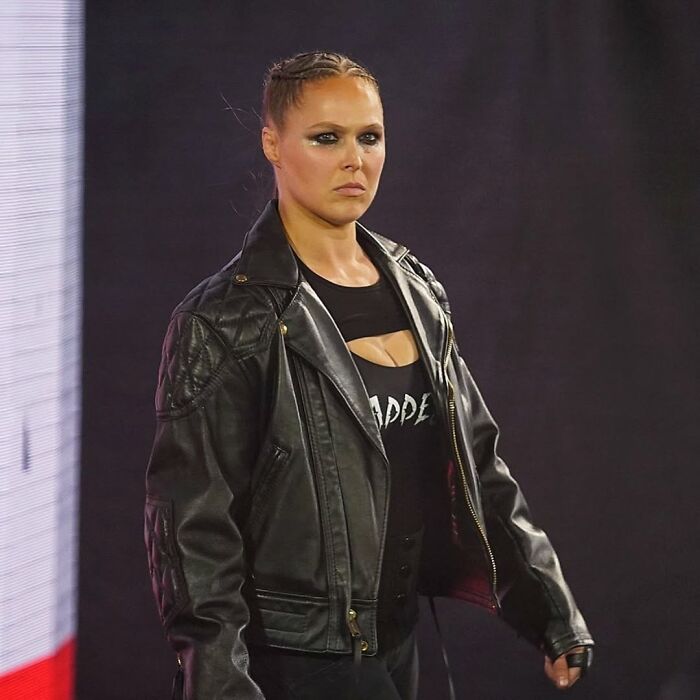 Ronda Rousey in a black leather jacket walking confidently, related to Ronda Rousey vs. Gina Carano Netflix fight discussion. Ronda Rousey in a black leather jacket walking confidently, related to Ronda Rousey vs. Gina Carano Netflix fight discussion.
