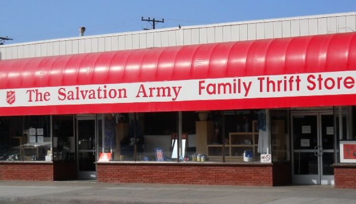 The Salvation Army Family Thrift Store storefront with red awning under clear blue sky, highlighting thrift store shopping.