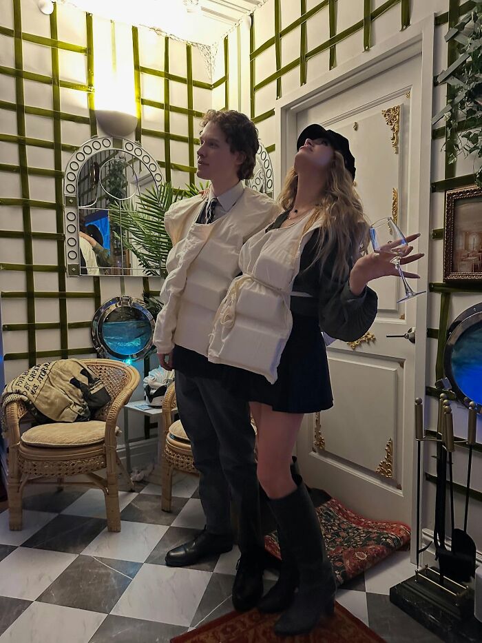 New York model wearing life jackets inside NYC apartment decorated as Titanic movie set holding a wine glass. New York model wearing life jackets inside NYC apartment decorated as Titanic movie set holding a wine glass.