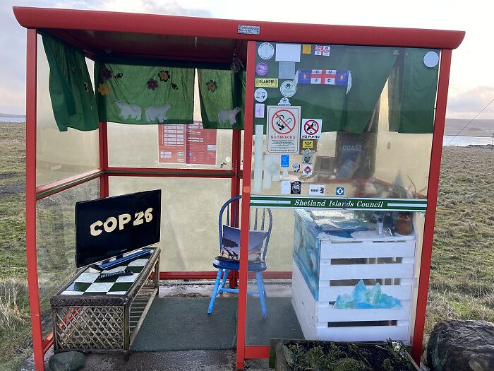 Small unique bus shelter with green curtains and COP26 sign, one of the unusual places around the world with Wikipedia pages