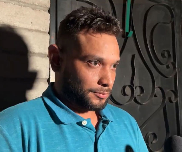 Man detained in connection with Nancy Guthrie kidnapping speaking during an interview in a blue polo shirt.