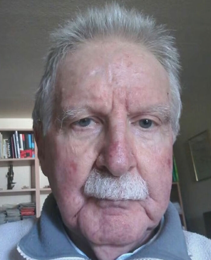 Elderly man with white hair and mustache in a room, related to teacher known for helping under-privileged students.