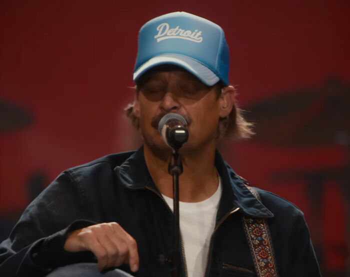 Kid Rock performing on stage wearing a Detroit cap during alternative halftime show breaking silence after backlash.