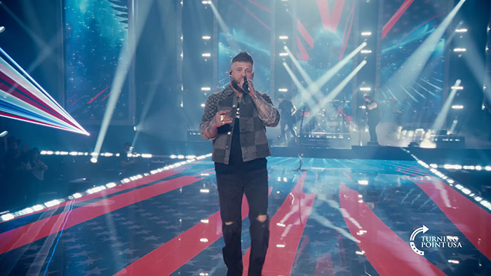 Kid Rock performing on stage at Turning Point USA alternative Super Bowl show amid online backlash.