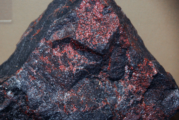 Close-up of a rock surface showing red markings related to archaeologists discovering traps at job sites.