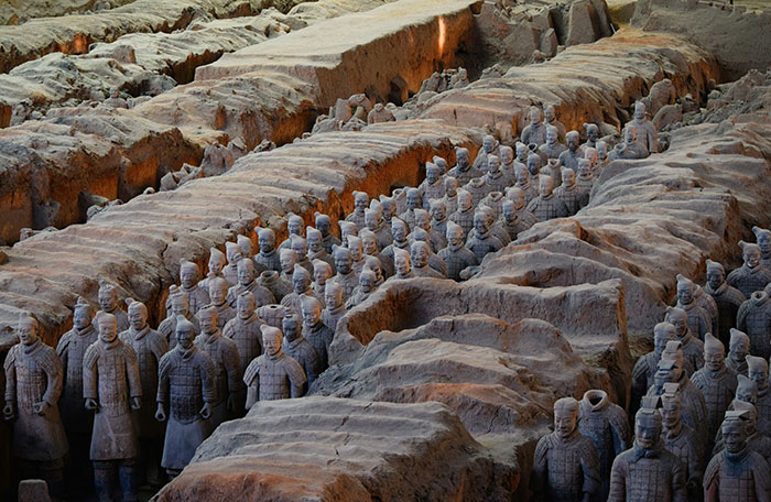 Ancient archaeological site showing terracotta warrior statues excavated from a historic job site danger traps.