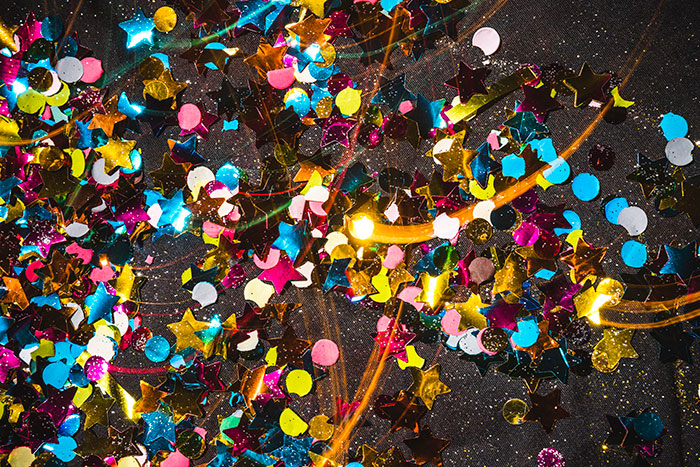 Colorful star and round confetti scattered, illustrating a festive trap symbol for archaeologists at job sites.