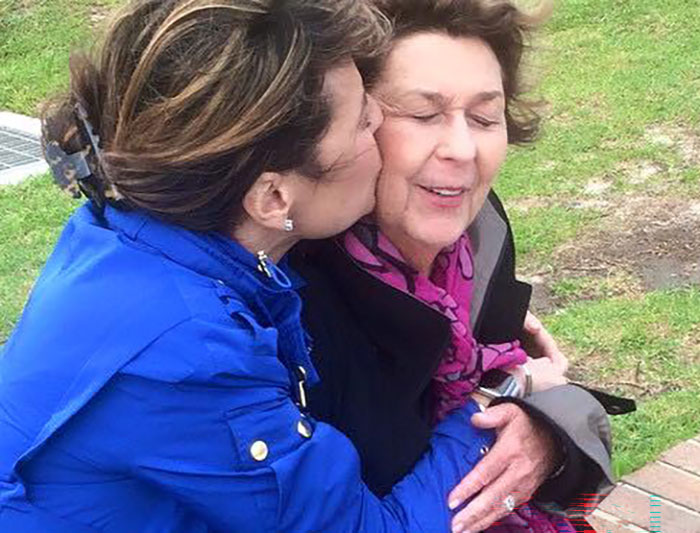 Two women share a tender moment outdoors, highlighting a key connection in the Savannah Guthrie missing mom case.