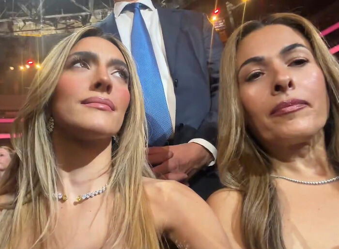 MAGA influencer Emily Austin with another woman at an event, reacting to Billie Eilish's anti-ICE Grammy speech