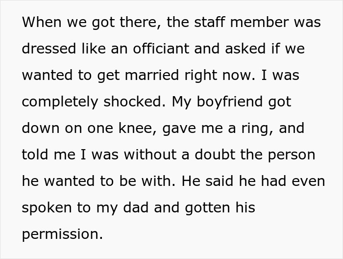 Couple experiencing a fake proposal at a love museum with a boyfriend down on one knee holding a ring.