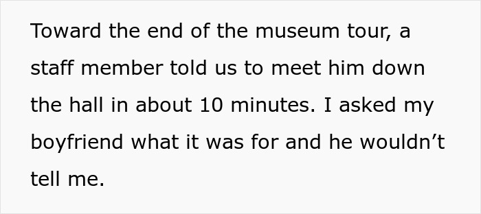 Couple on a museum tour with boyfriend planning a fake proposal, creating a memorable love moment.