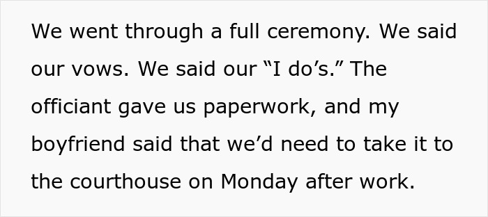 Couple reenacting a fake proposal ceremony inside a love museum, exchanging vows and paperwork during the event.